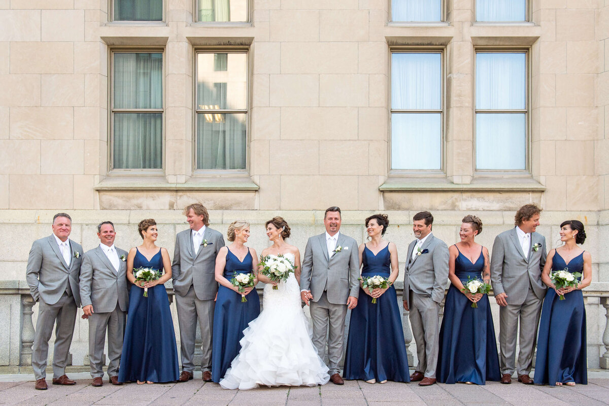 a group photo of an elegant bridal party on the terrace of the Chateau Laurier wedding venue.  Captured by Ottawa wedding photographer JEMMAN Photography