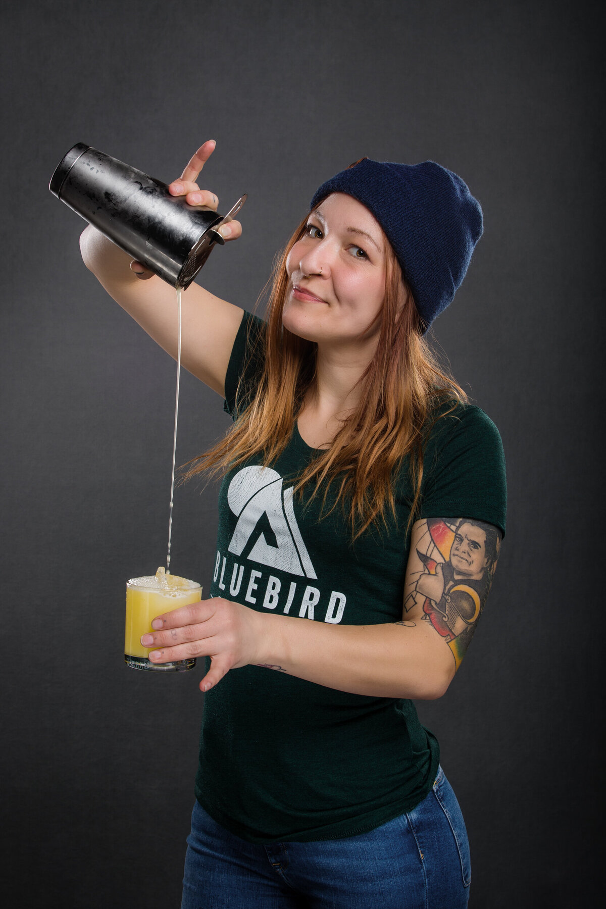Branding photo of a woman bar tender pouring drinks