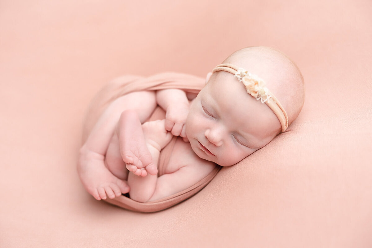 baby girl in blush wrap