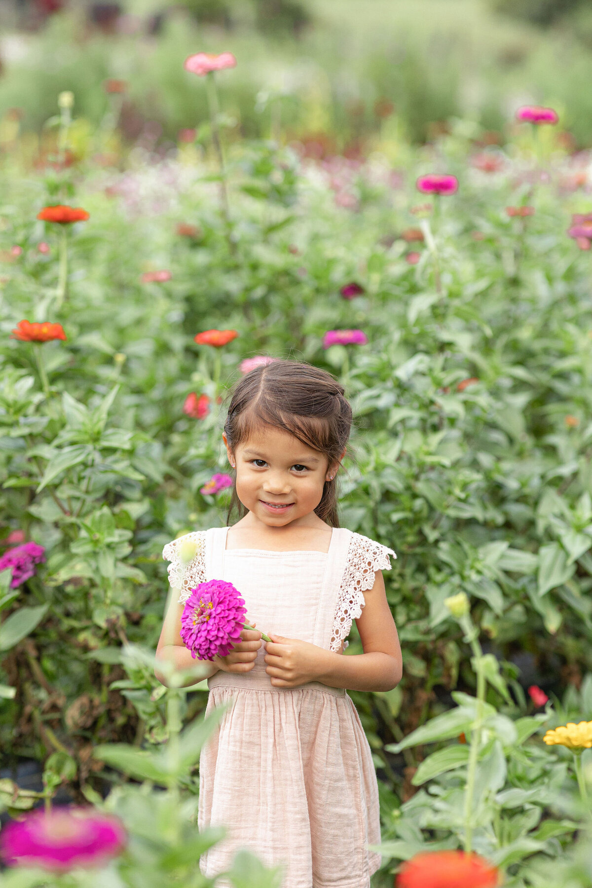 Girl holding a flower in Chickapoo farm