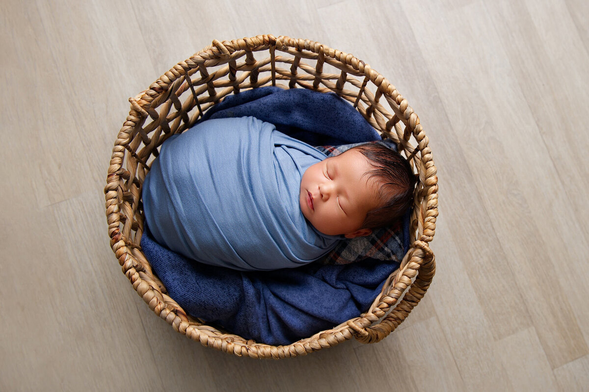 baby boy in a big basket