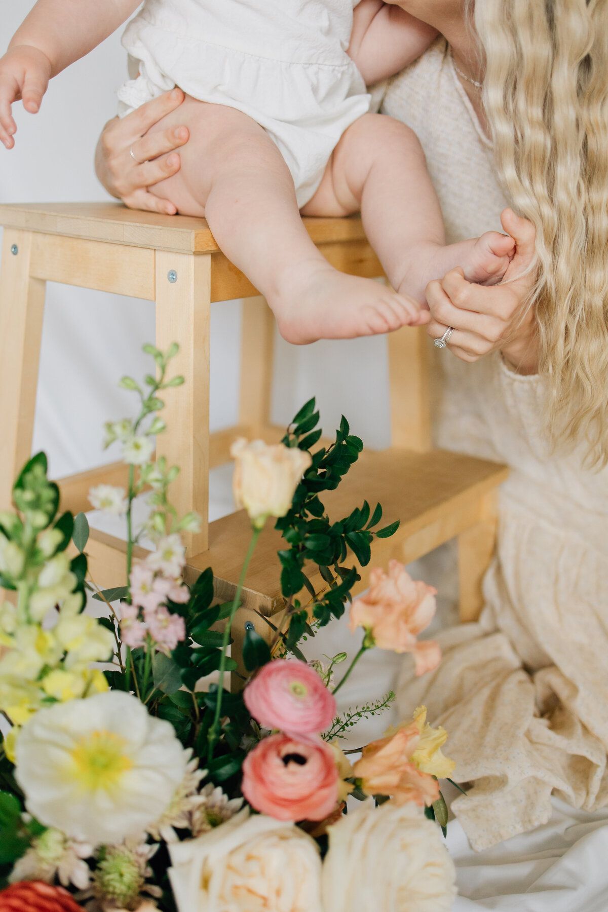 Motherhood session with florals taken in studio located in Lewsiville, TX