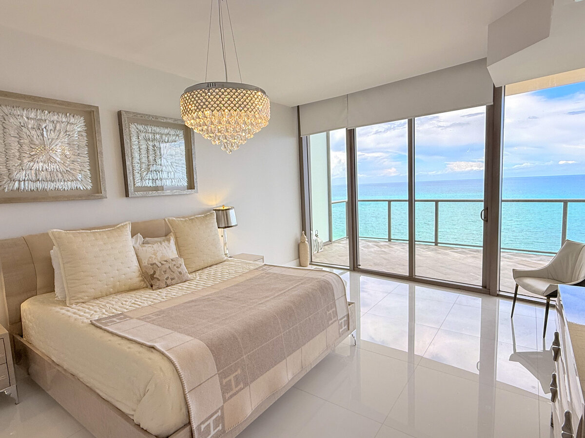 Elegant master bedroom with water views and designer lighting at PH-888, St. Regis Bal Harbour