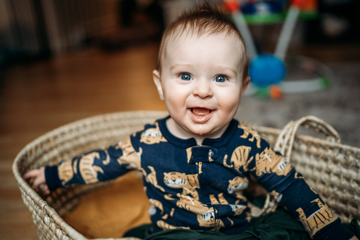 baby smiling in a bassinet