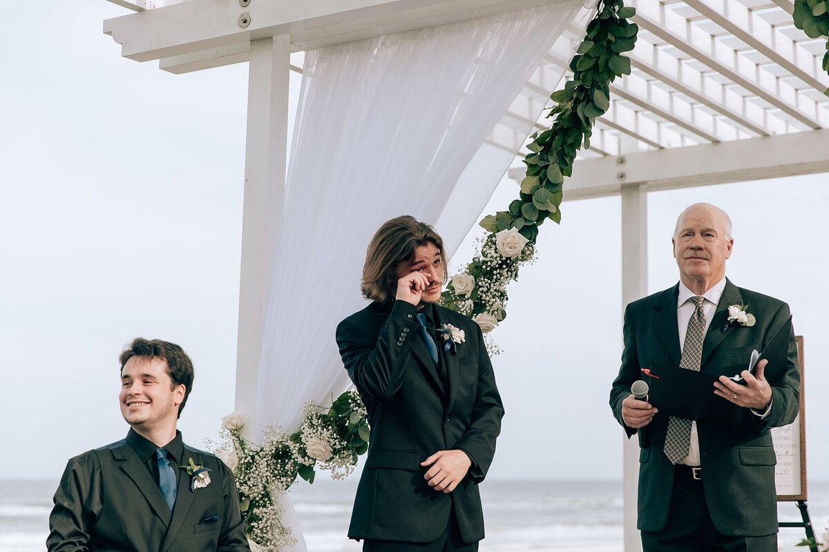 groom crying as his bride walks down the aisle