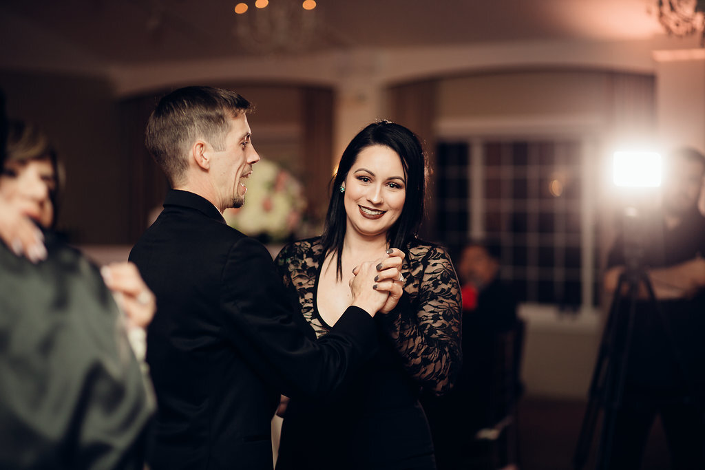 Wedding Photograph Of Man In Black Suit Dancing With a Woman In Black Dress Los Angeles