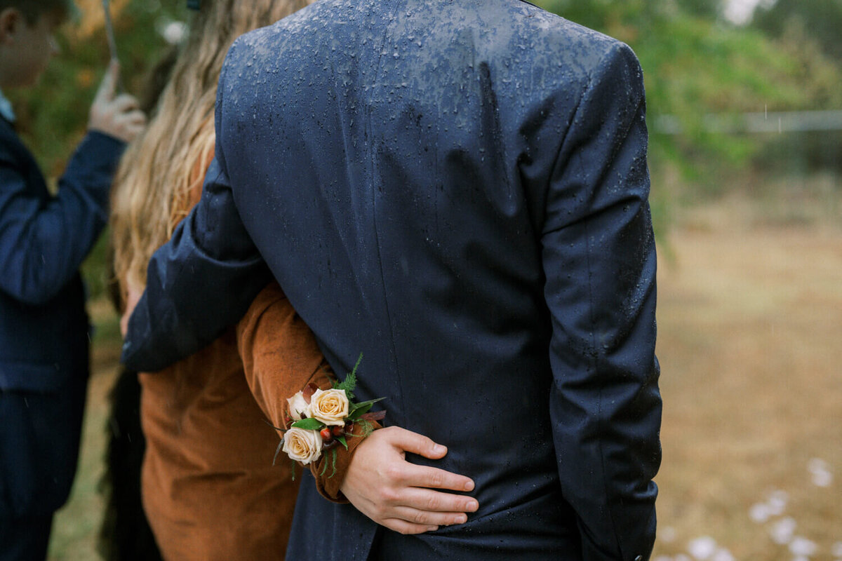 close-up-of-rain-soaked-wedding-suit