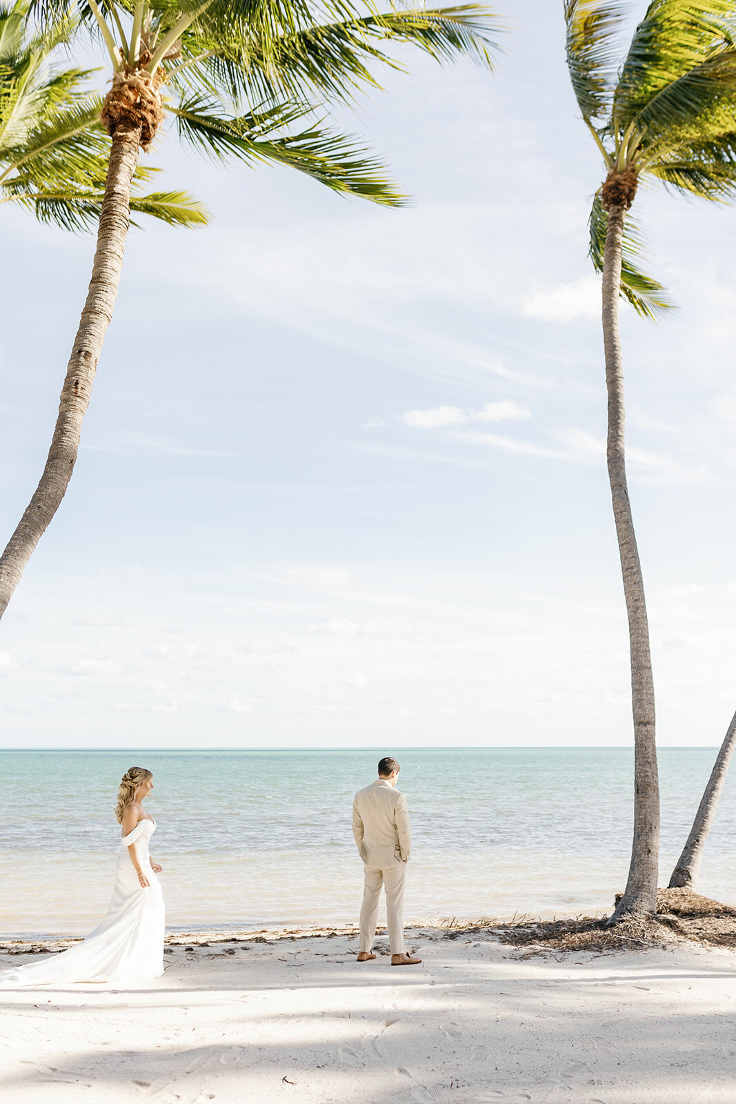 Monica approaches Austyn for a heartfelt first look moment on the sandy shores of Islamorada, Florida Keys.