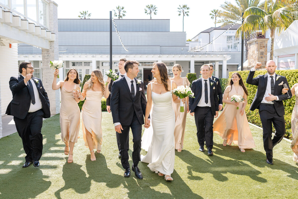 Bride and groom walk through their wedding party celebrating at Lido House