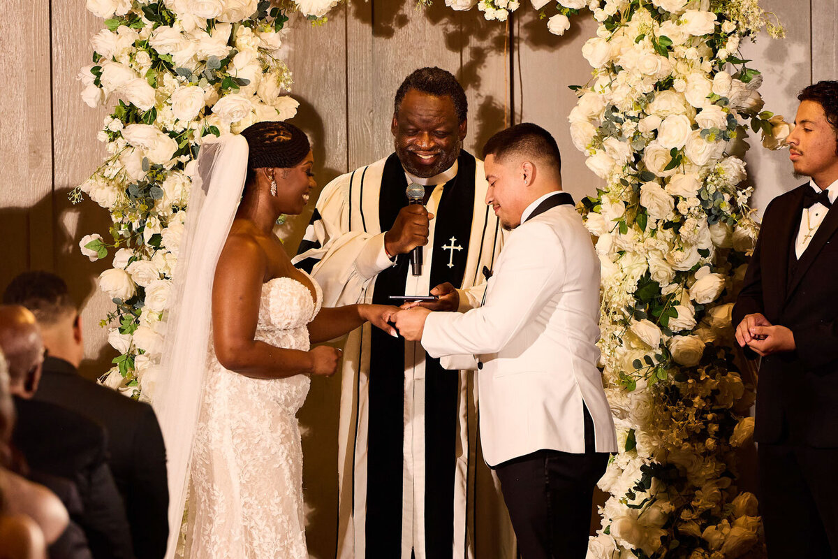 Groom putting on bride's ring