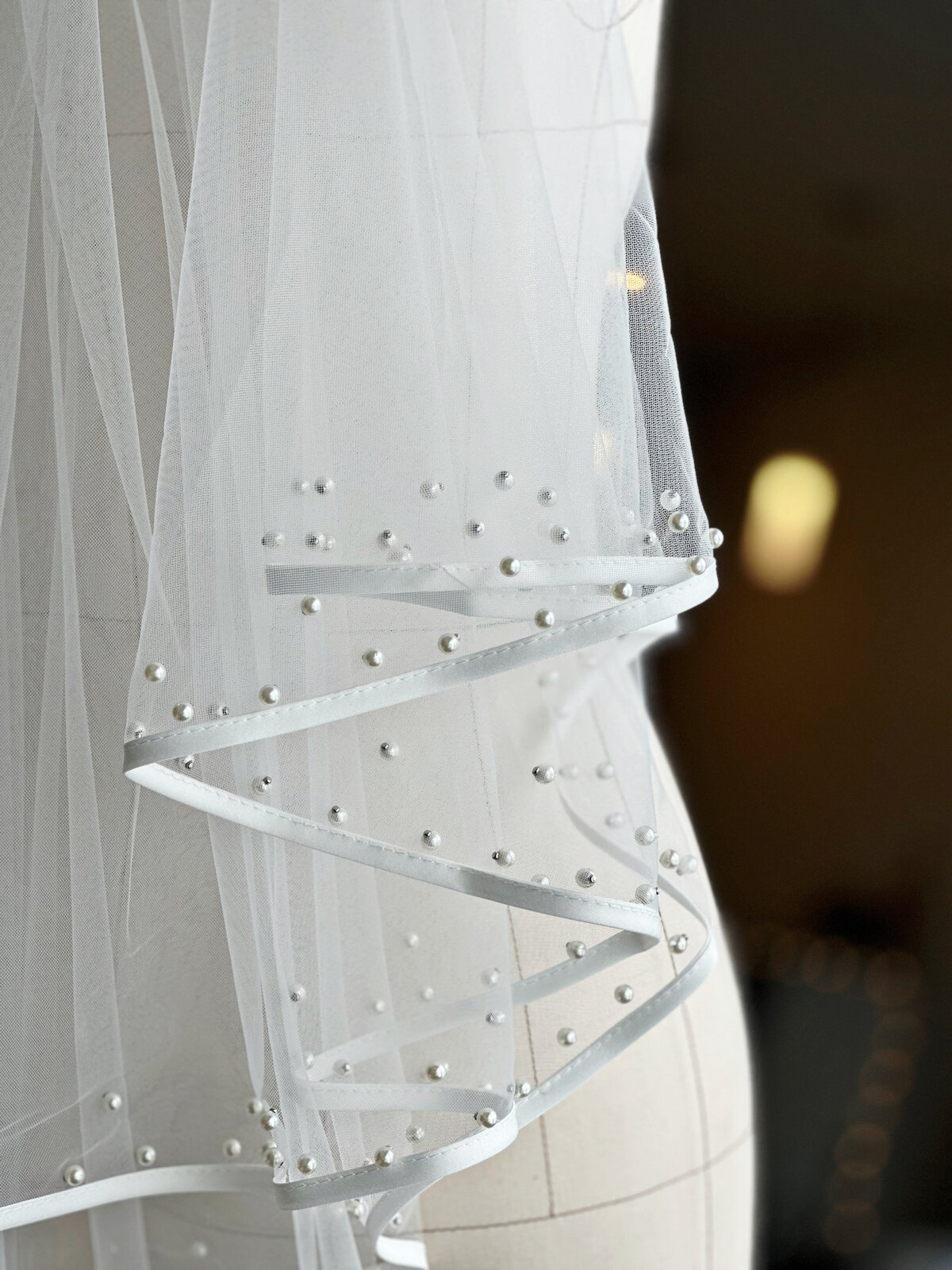 Airy pearl edge blusher veil gently framing the bride’s face
