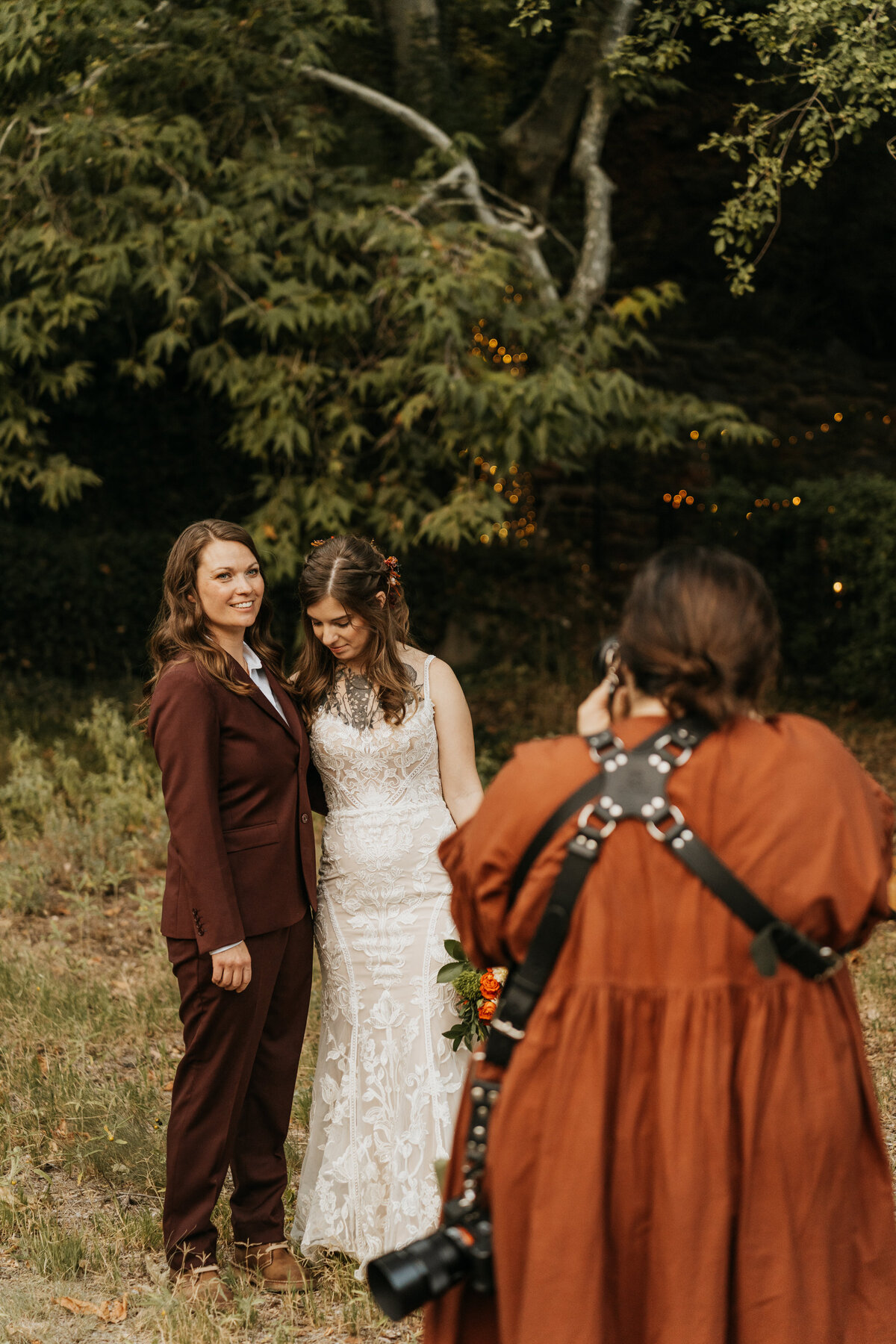A photographer taking a picture of a newlywed couple 