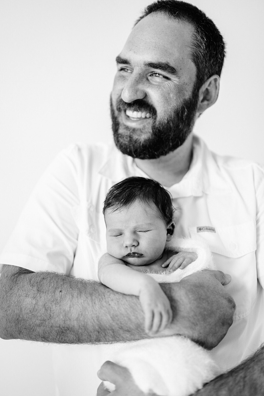 father smiling with his baby.