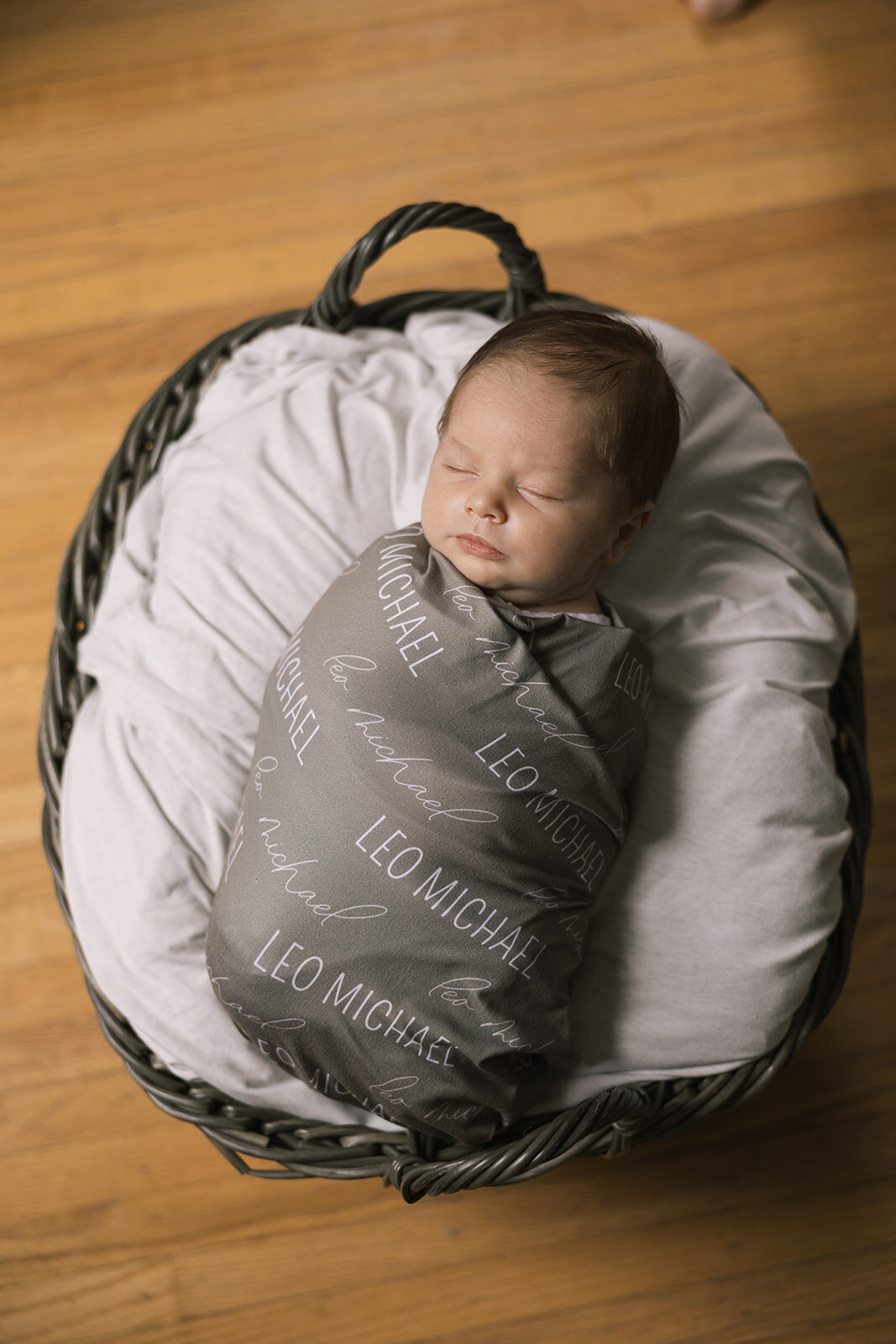 Swaddled baby in a basket