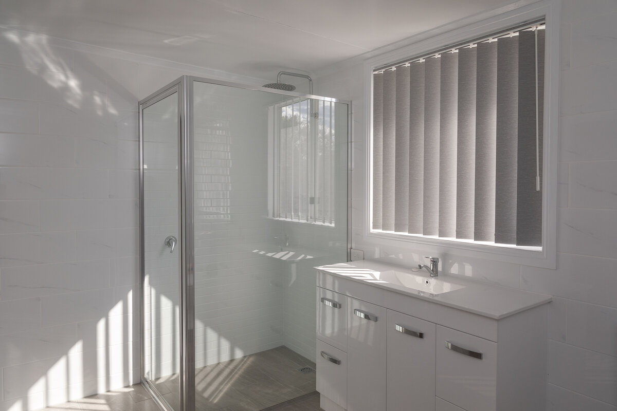 Sleek bathroom with custom frameless shower screens for a contemporary look.