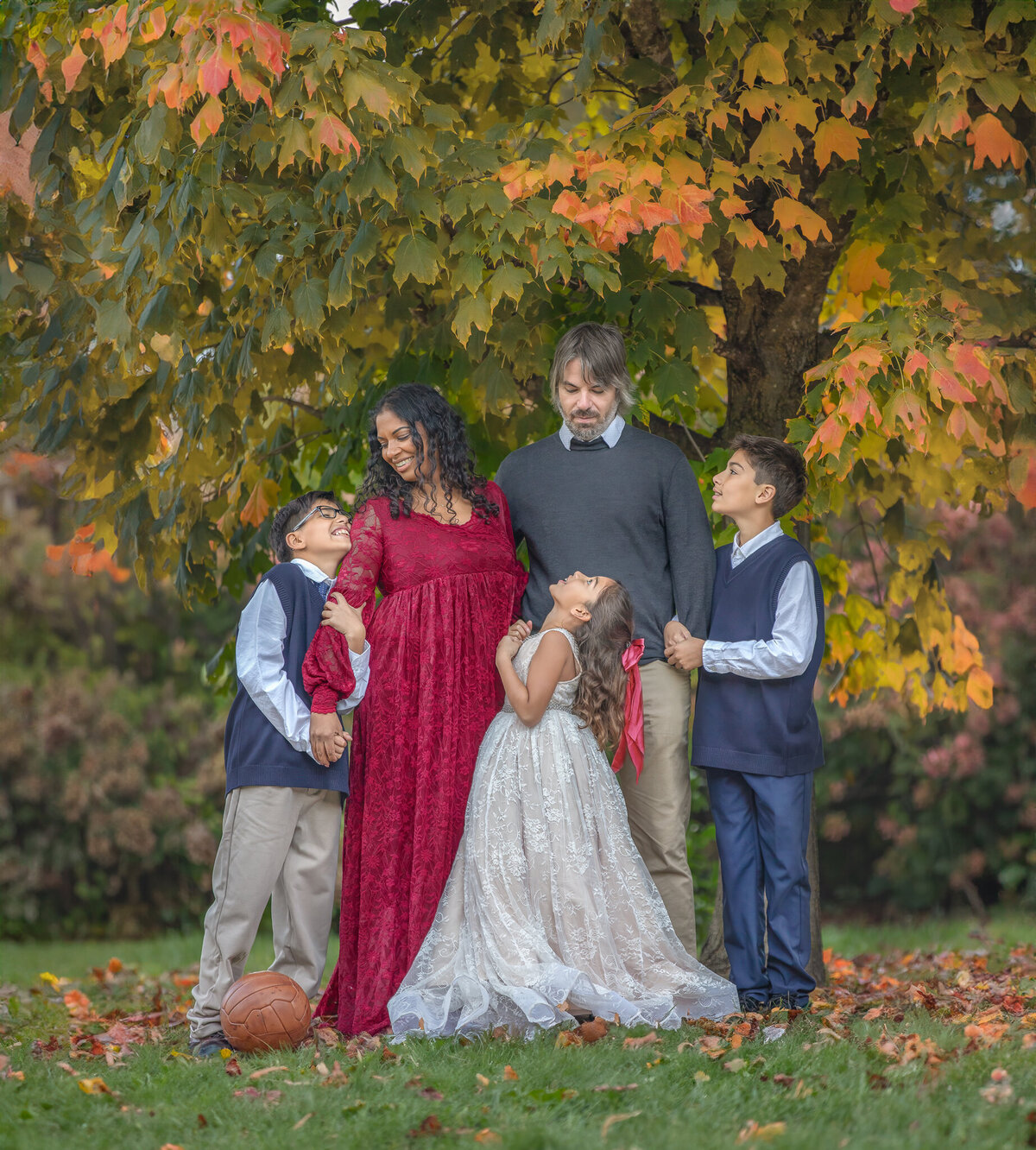 Family posing together in formal outfits among colorful fall foliage – Outdoor autumn session in Ottawa by Sonia Gourlie Fine Art Photography