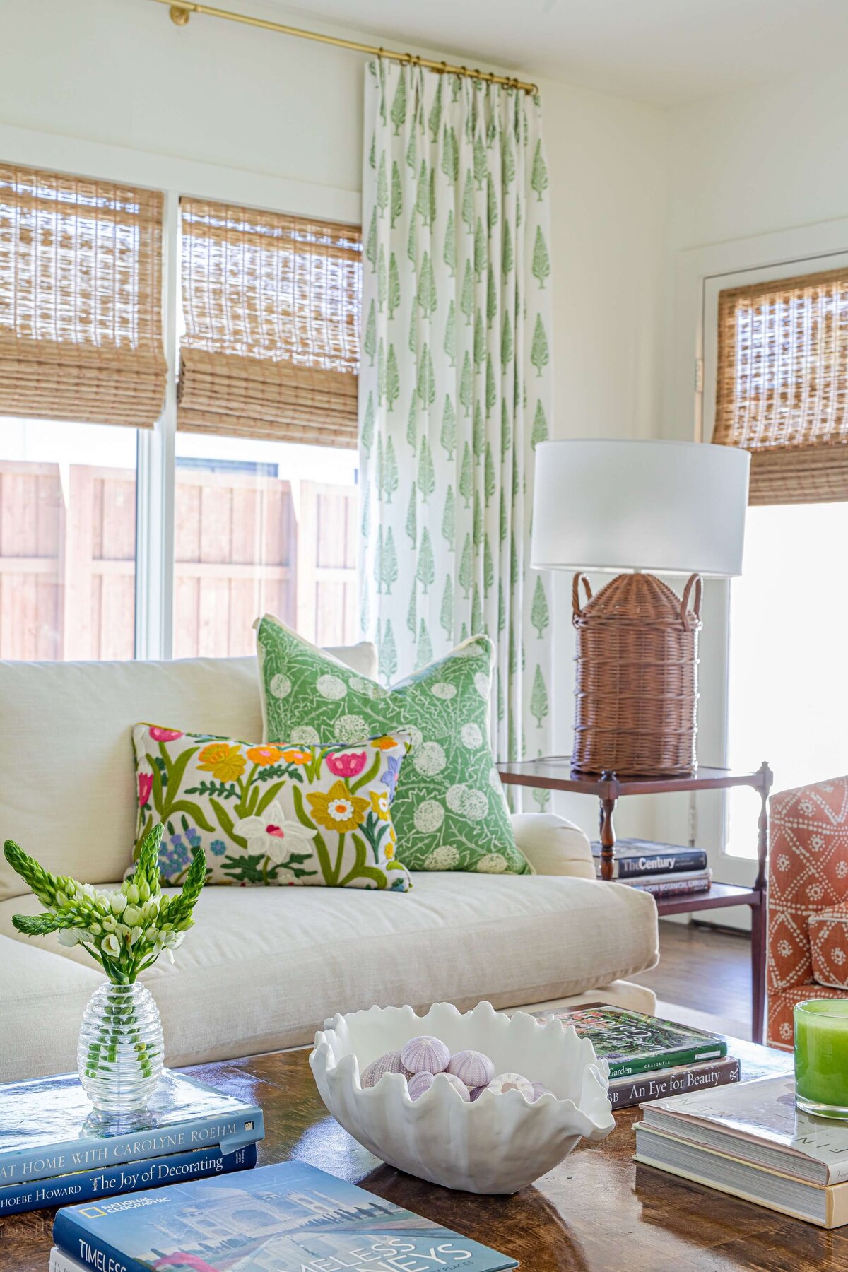 oyster creek studios highland park home white couch with colorful pillows and green curtains in living room