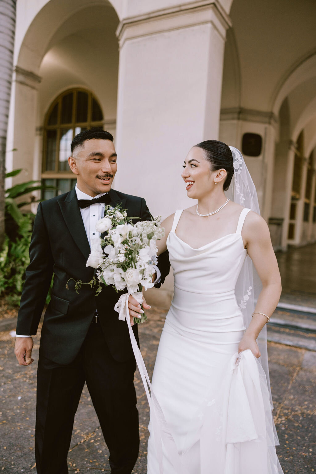 bride and groom walking and laughing
