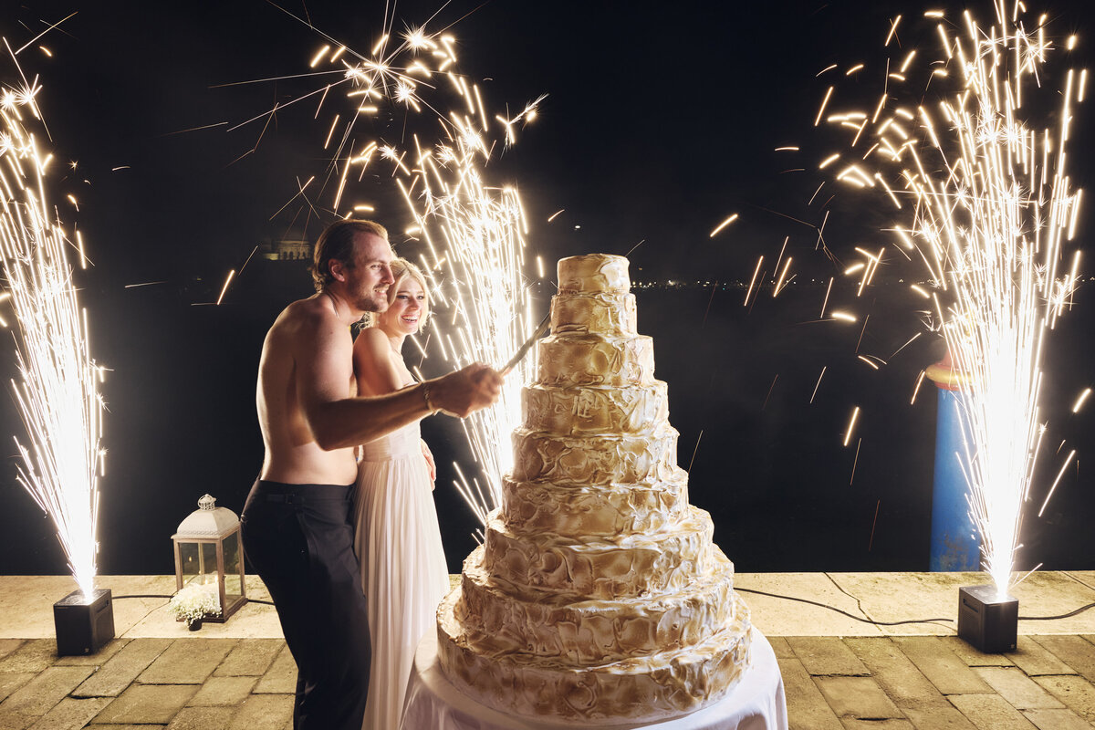 Ryan Pulock and wife Danielle at wedding cutting cake