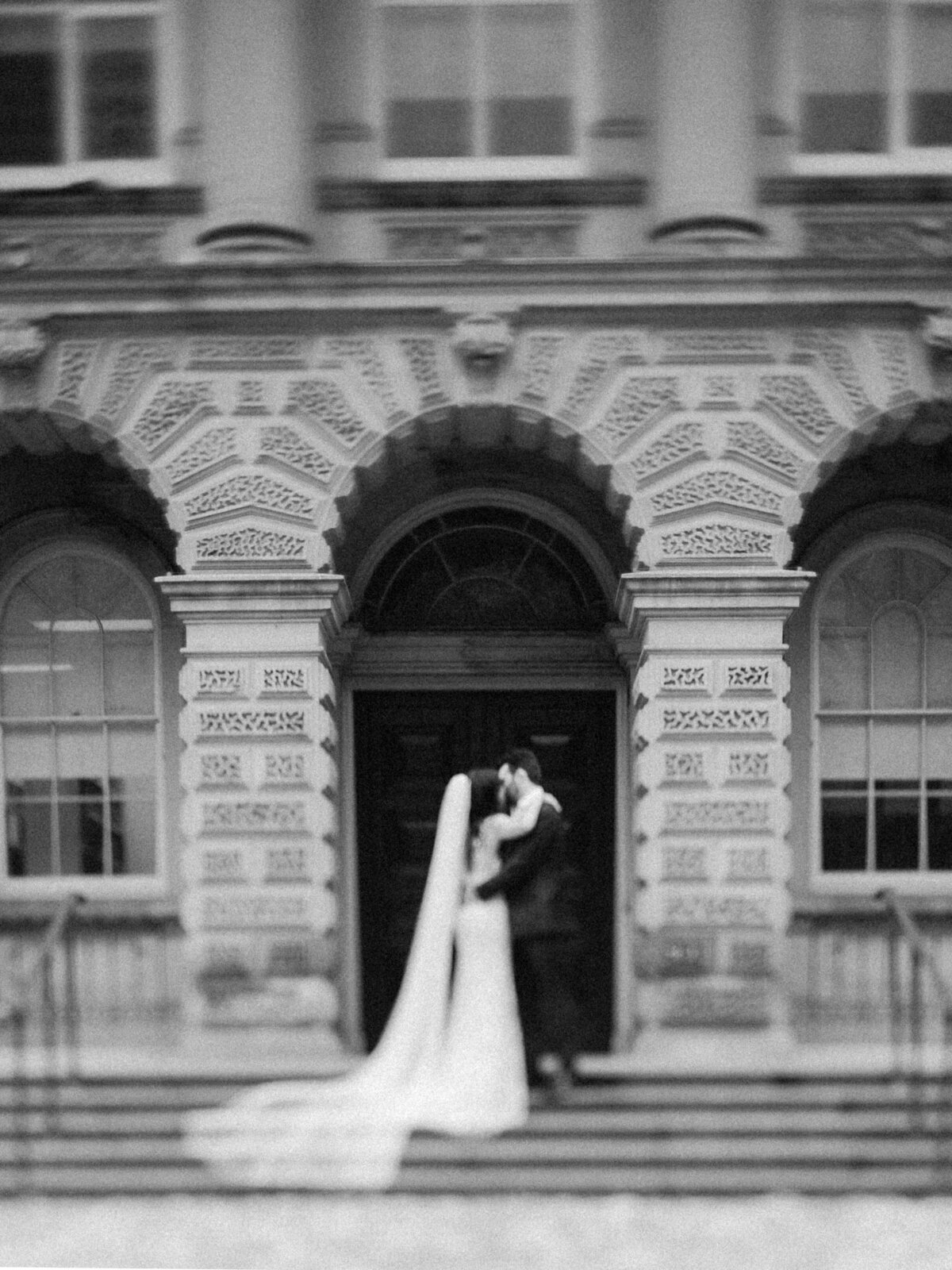 Bride and groom kiss at osgoode hall