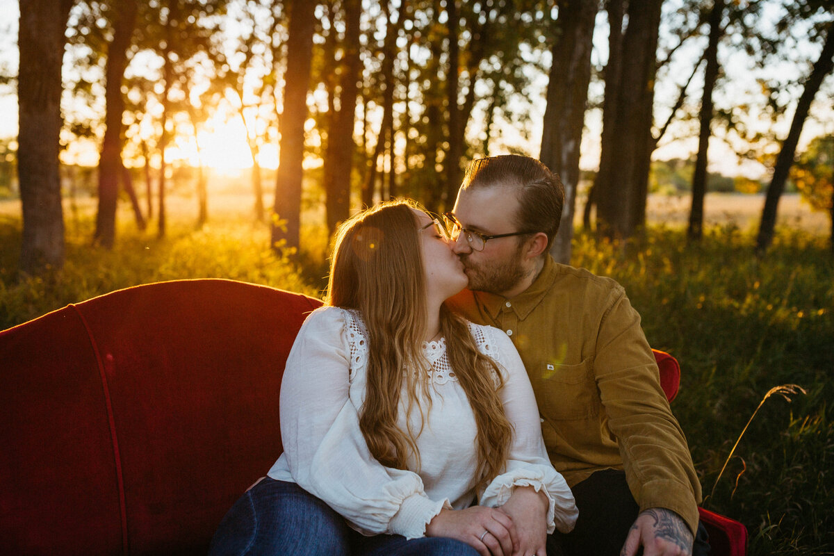 couple-kissing-on-couch-engagement-photos