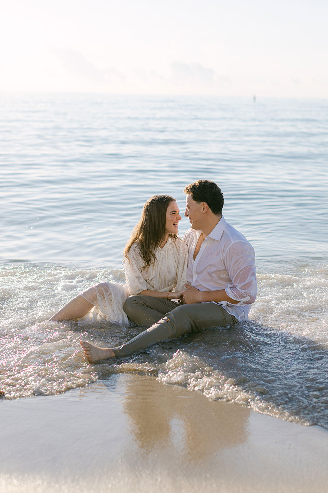 couple-sitting-in-ocean-4CD-ES