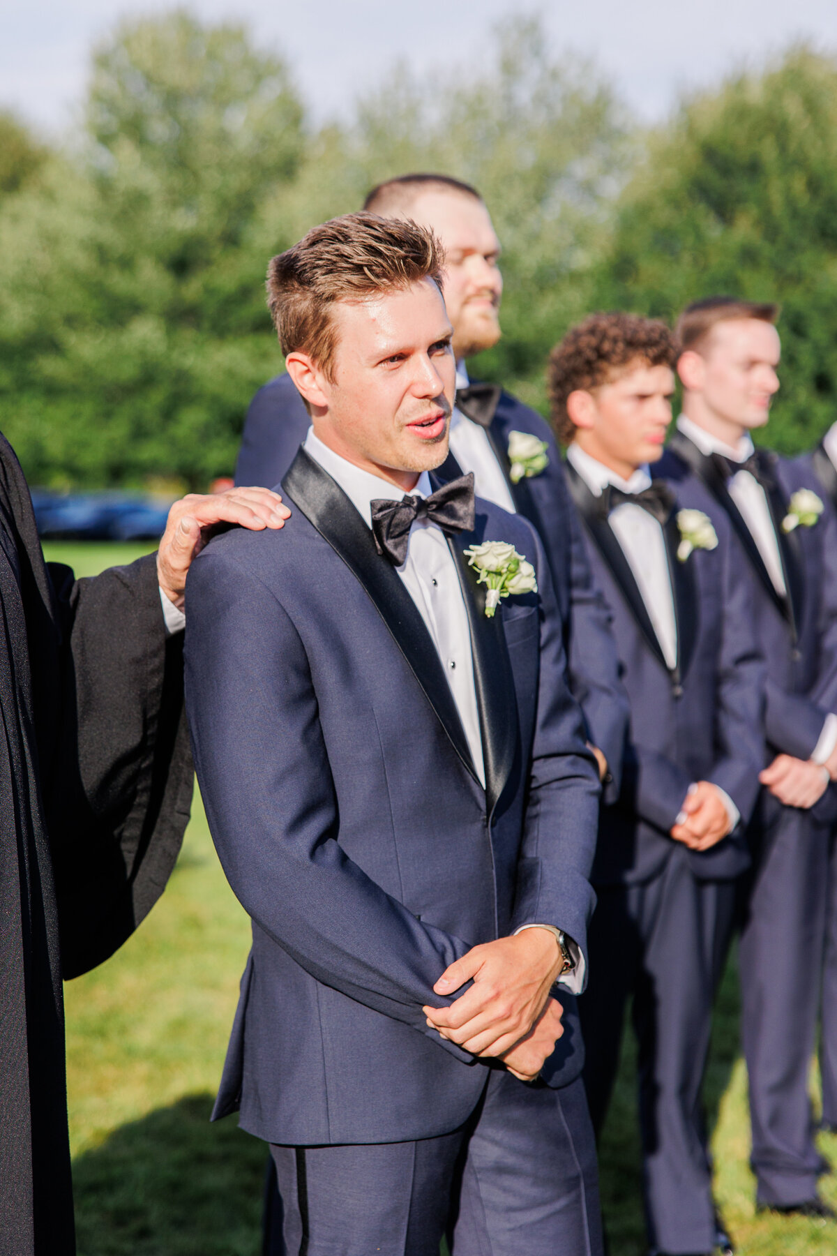 Groom looking emotional and excited as bride walks down the aisle representing joyful Boston wedding photography
