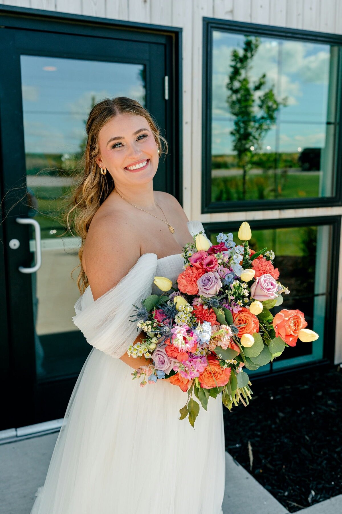 bride-holding-flowers-barn