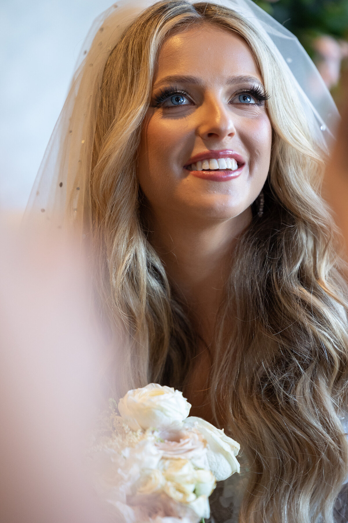 A close up of a bride smiling