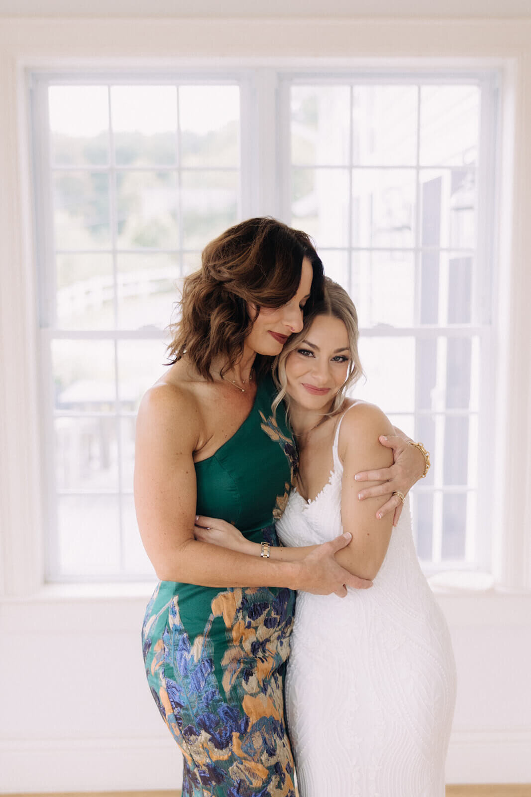 Bride hugging friend before Finger Lakes wedidng