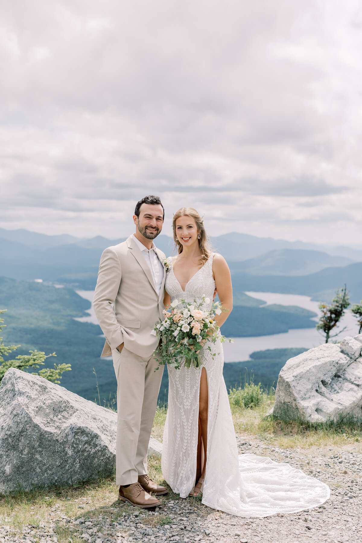 Bride and Groom smiling on the top of Whiteface on their wedding day.