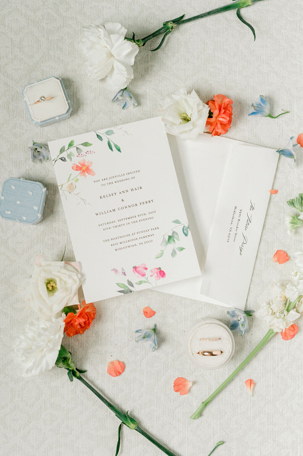Light image of a white and floral invitation suite