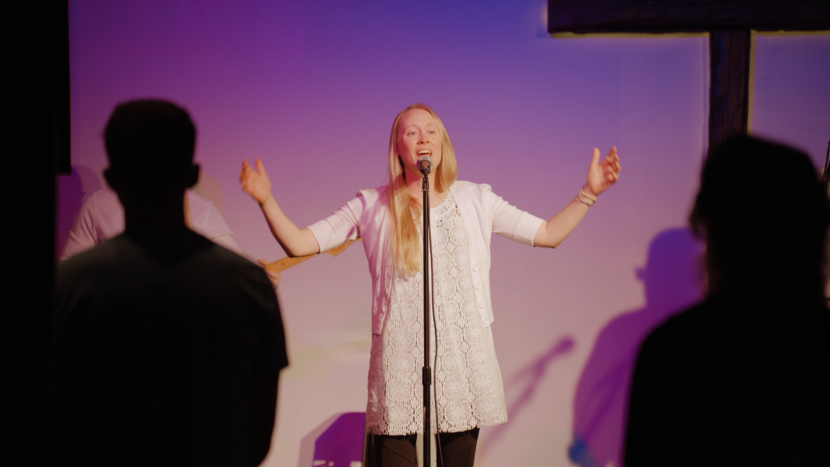 A woman singing on stage