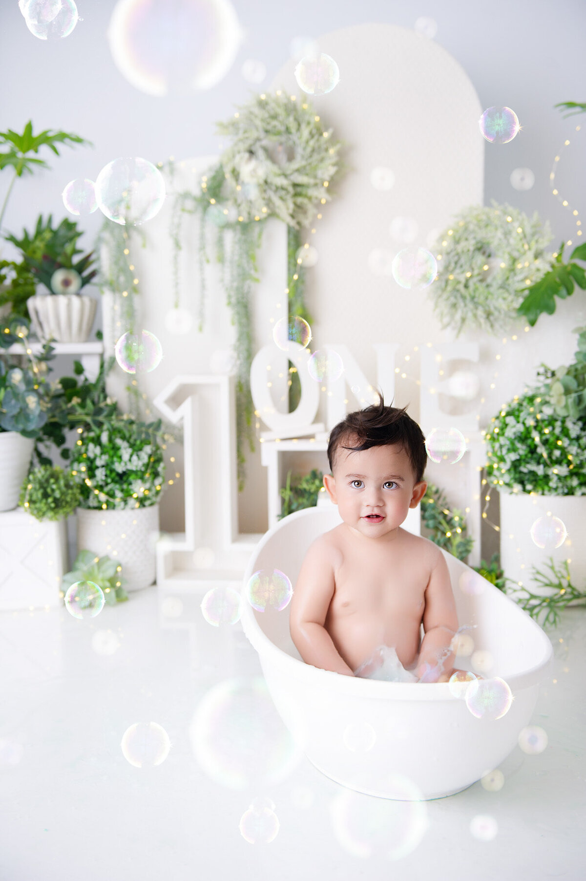 boy in tiny white bath taking a milkbath