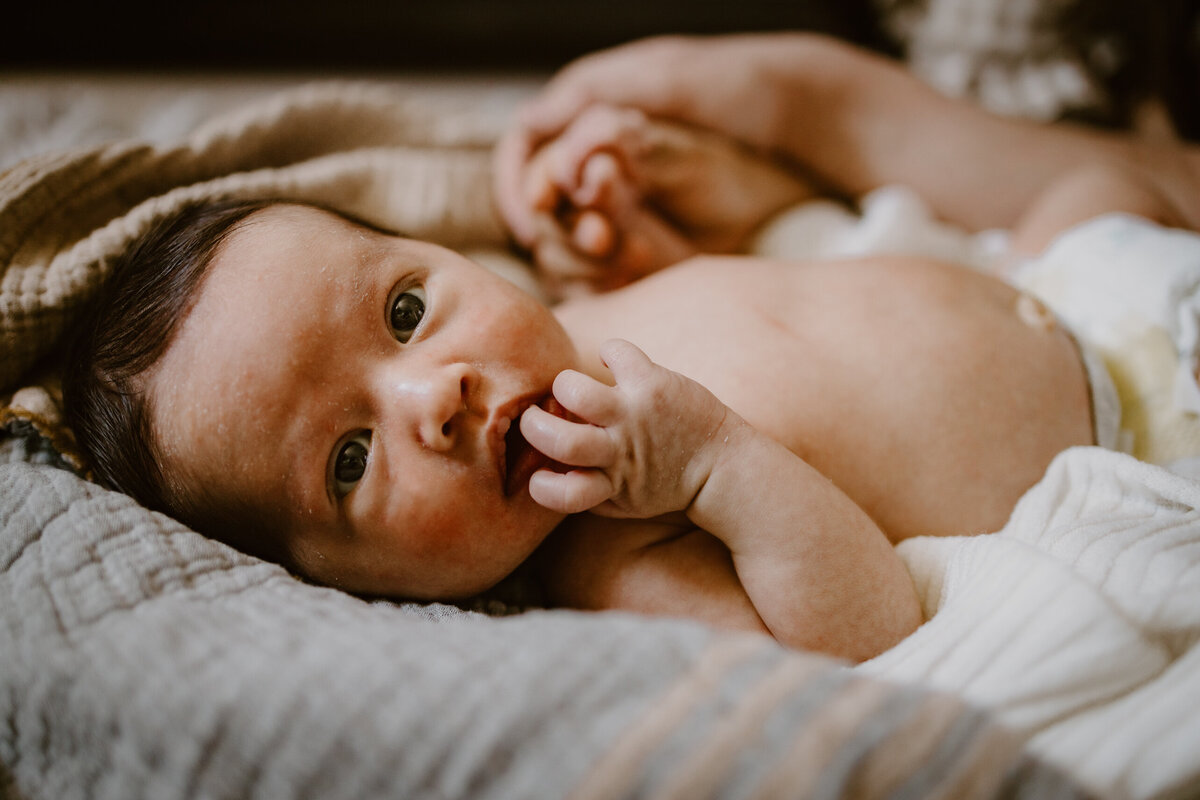 Newborn sucking fingers