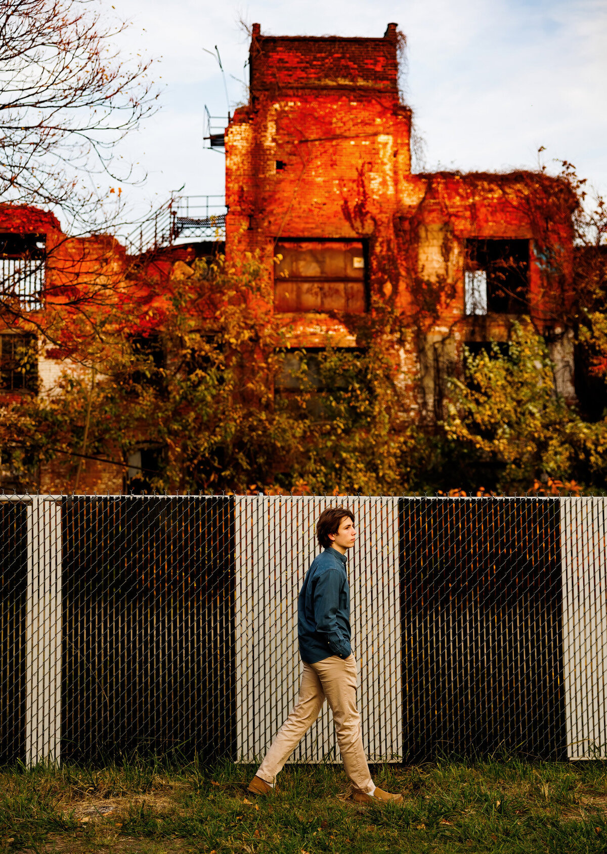 A Gilmour Academy senior walks by an abandoned building.