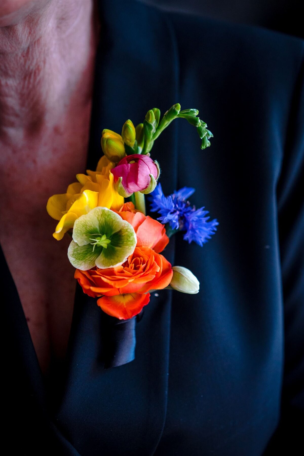 Colorful boutonniere with unique wedding flowers. Artistic floral design for wedding venues on the Eastern Shore near Easton, Maryland.