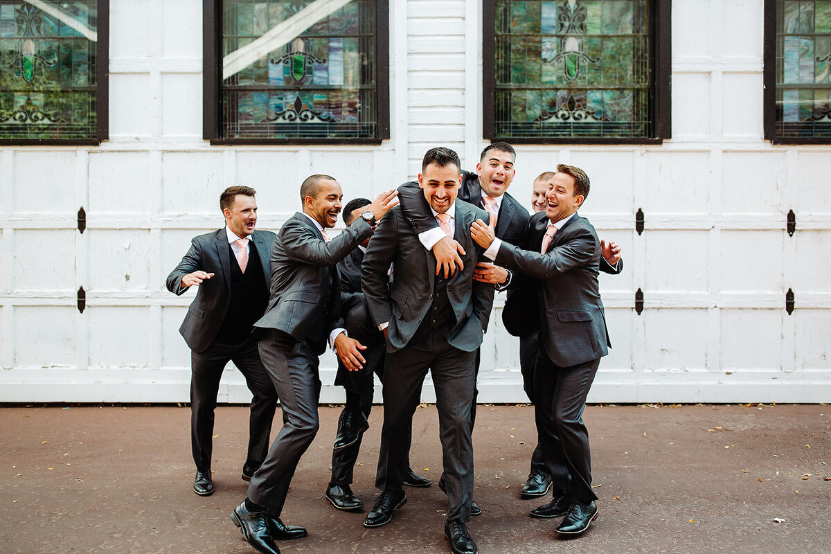 Groom and groomsmen pose together before their wedding.