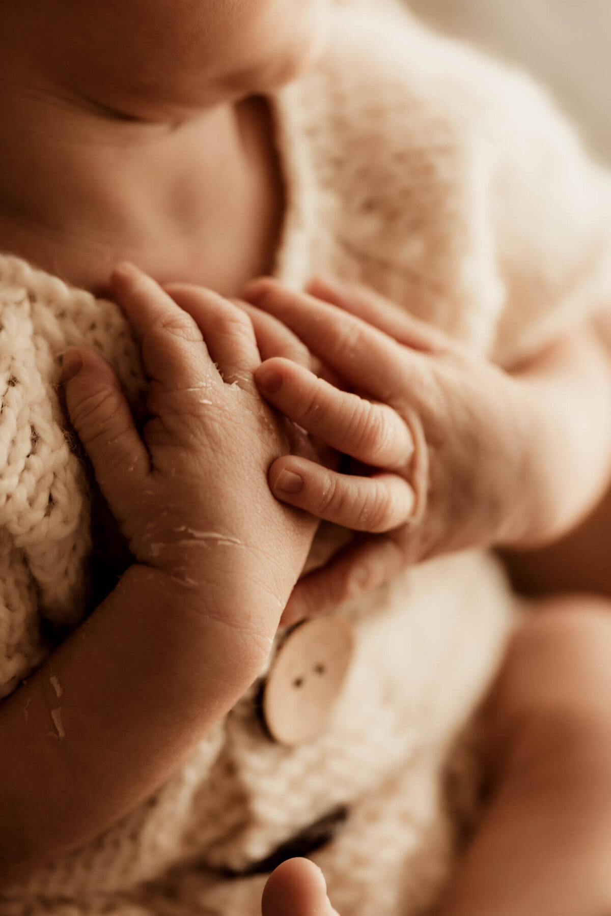 Newborn baby boy's delicate hands.
