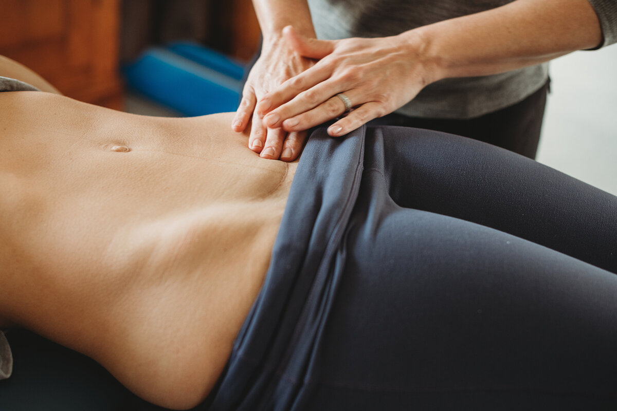 Practitioner massages patient's cesarean scar