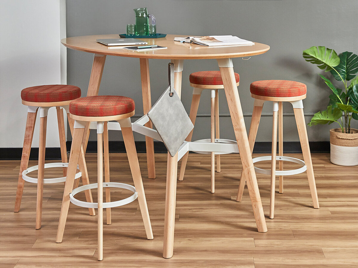 modern high-top table with red fabric covered stools