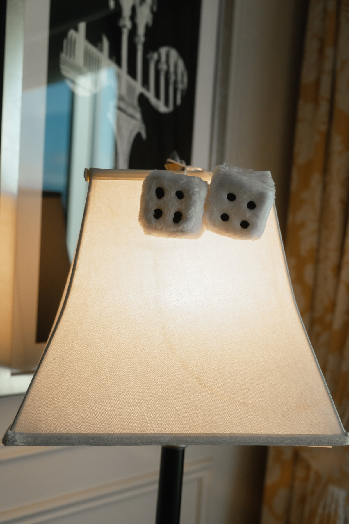 fun wedding detail photo of dice sitting on a lamp