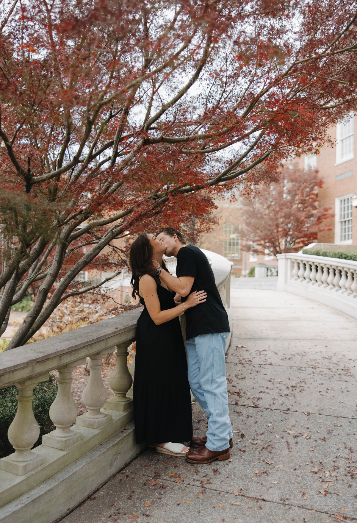 man kissing his wife near a beautiful stone ramp