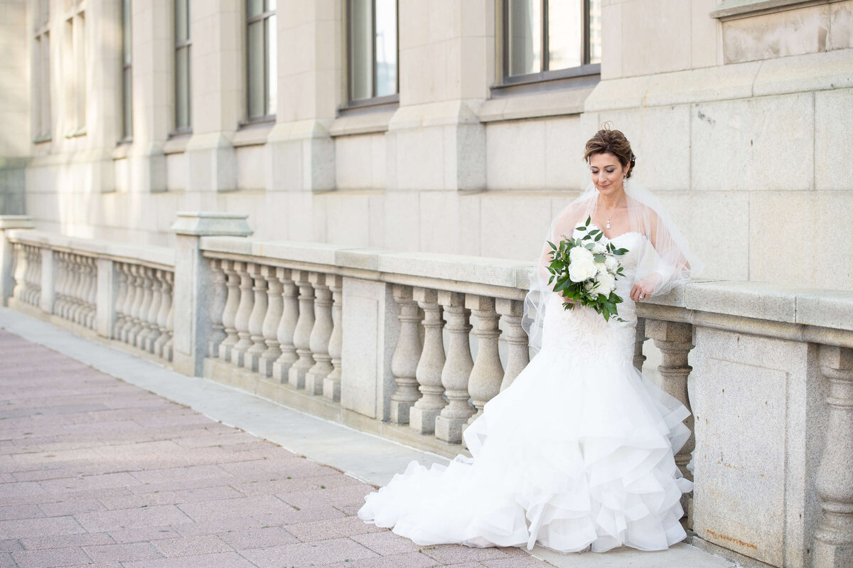a full length photo showing the dress and bouquet of a mature elegant Ottawa bride