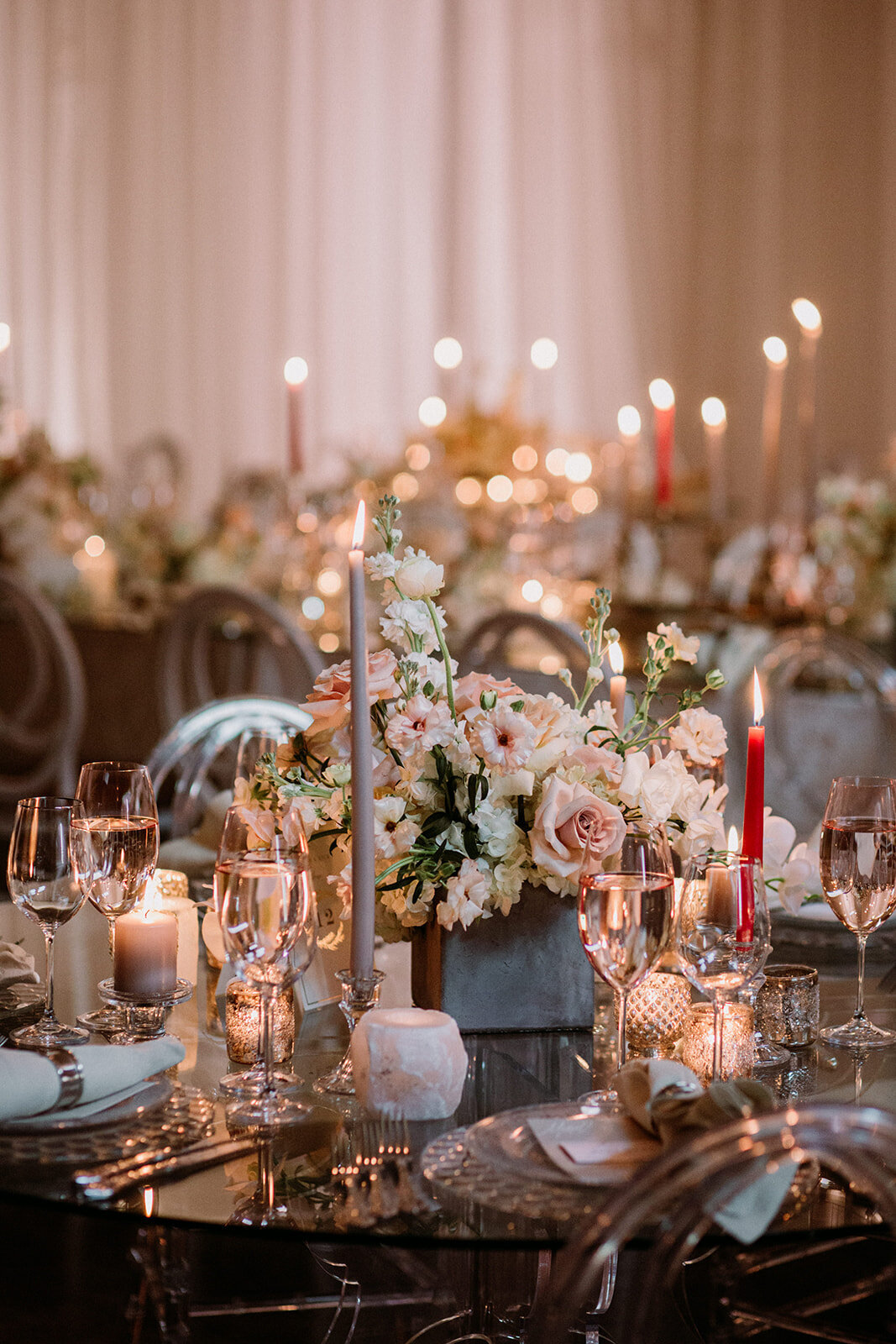 Elegant floral centrepieces of lush pastel flowers at a wedding reception at Entrepot Dominion.