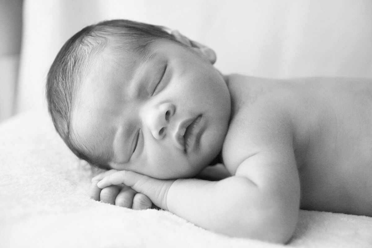 Minimal newborn photo on bed in natural light — San Francisco photographer