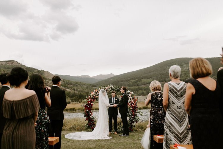 Bride and groom at the altar during the wedding ceremony at an outdoor venue in Colorado
