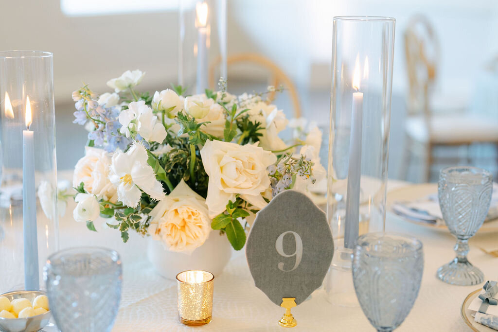 low centerpieces, taper candles, candle light, blue glasses