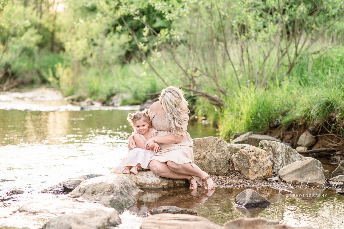 Mother and daughter sitting on rock by creek in york pa photographer maternity newborn family