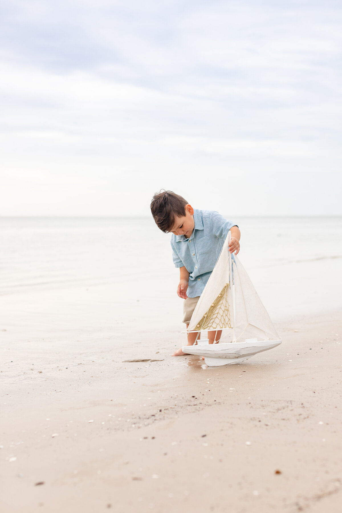 Boy playing on the beach during a family session in St. Augustine Beach